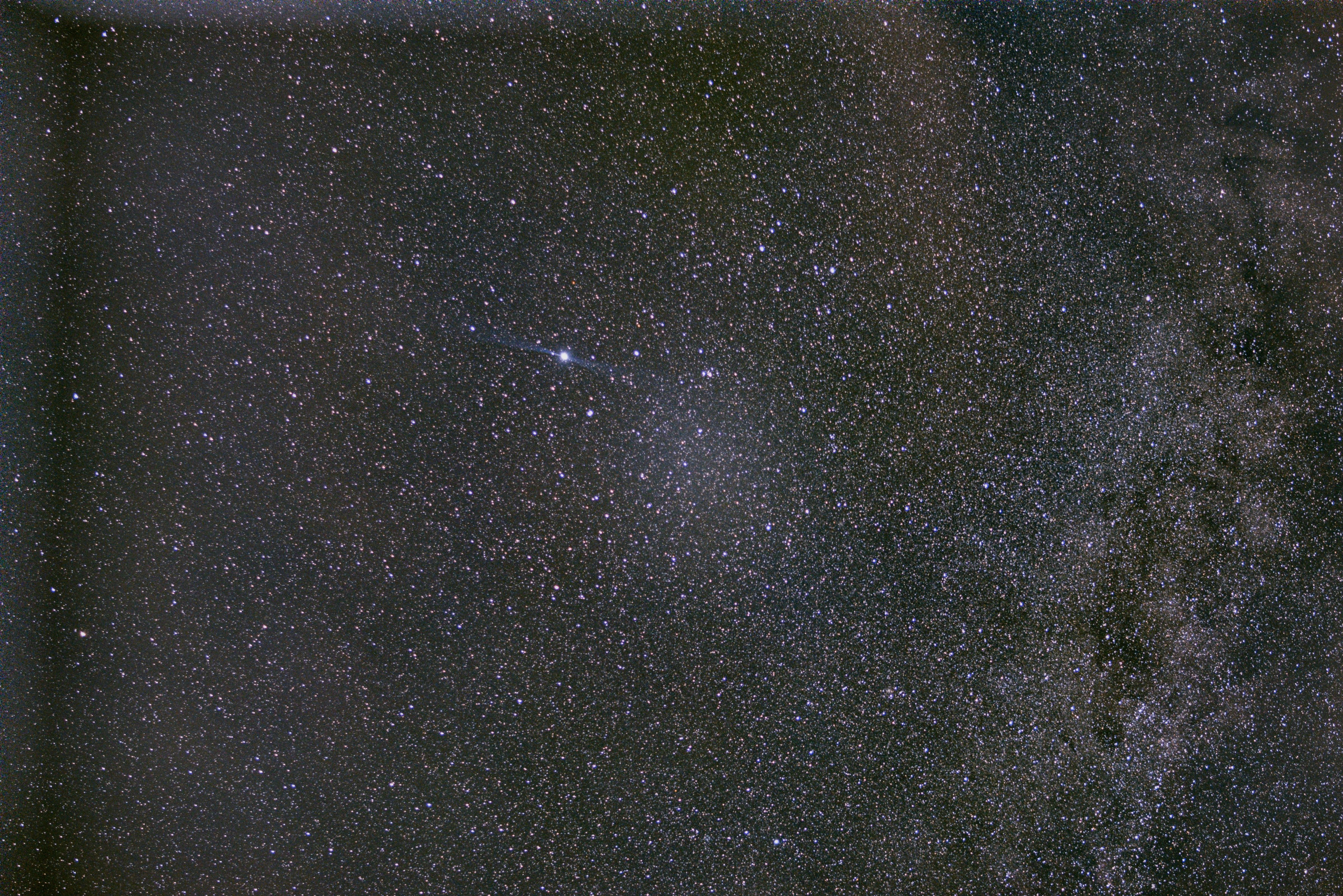 A dense field of stars and the Milky Way crossing a dark night sky