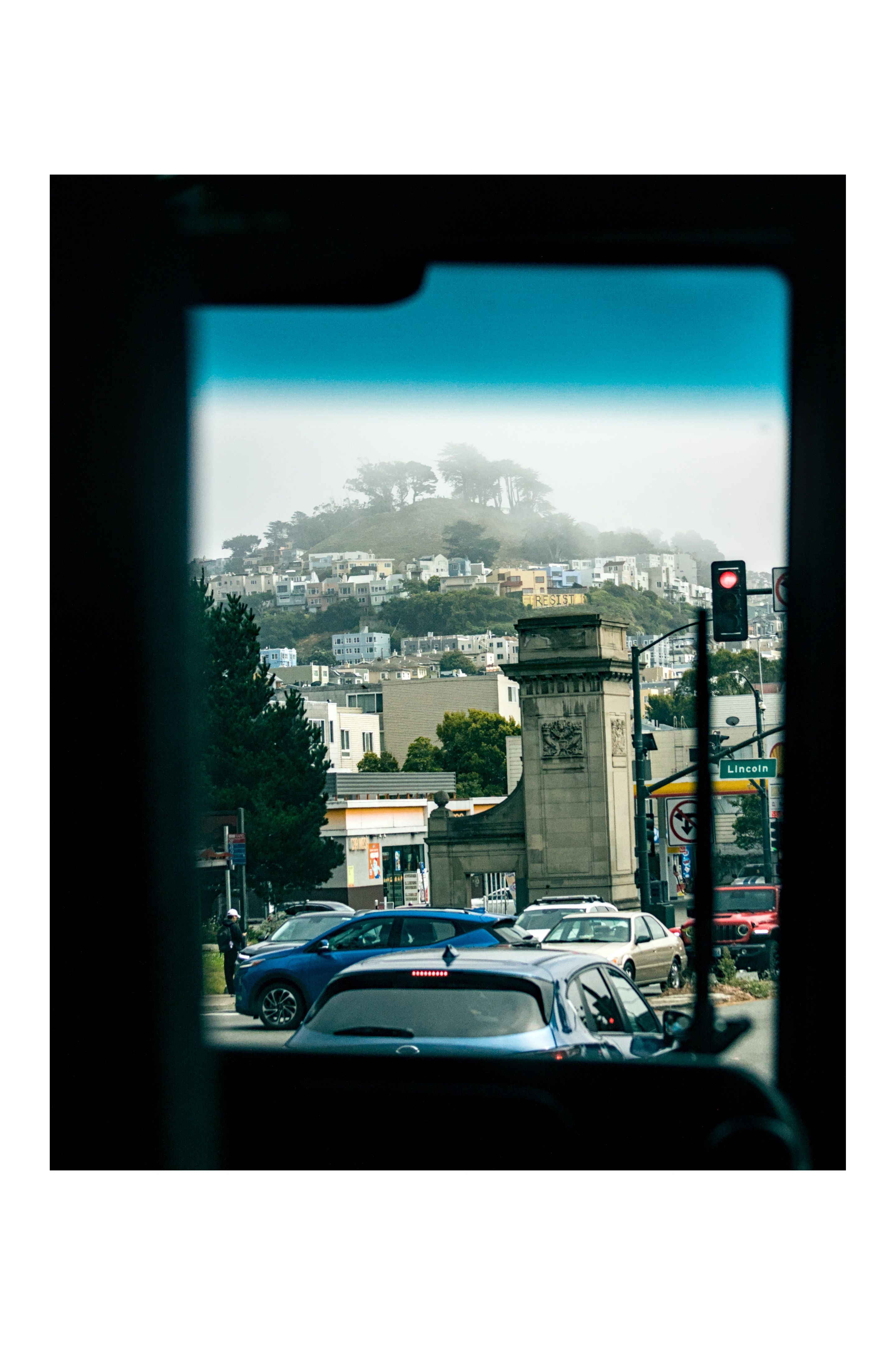 A San Francisco street framed by a dark bus window