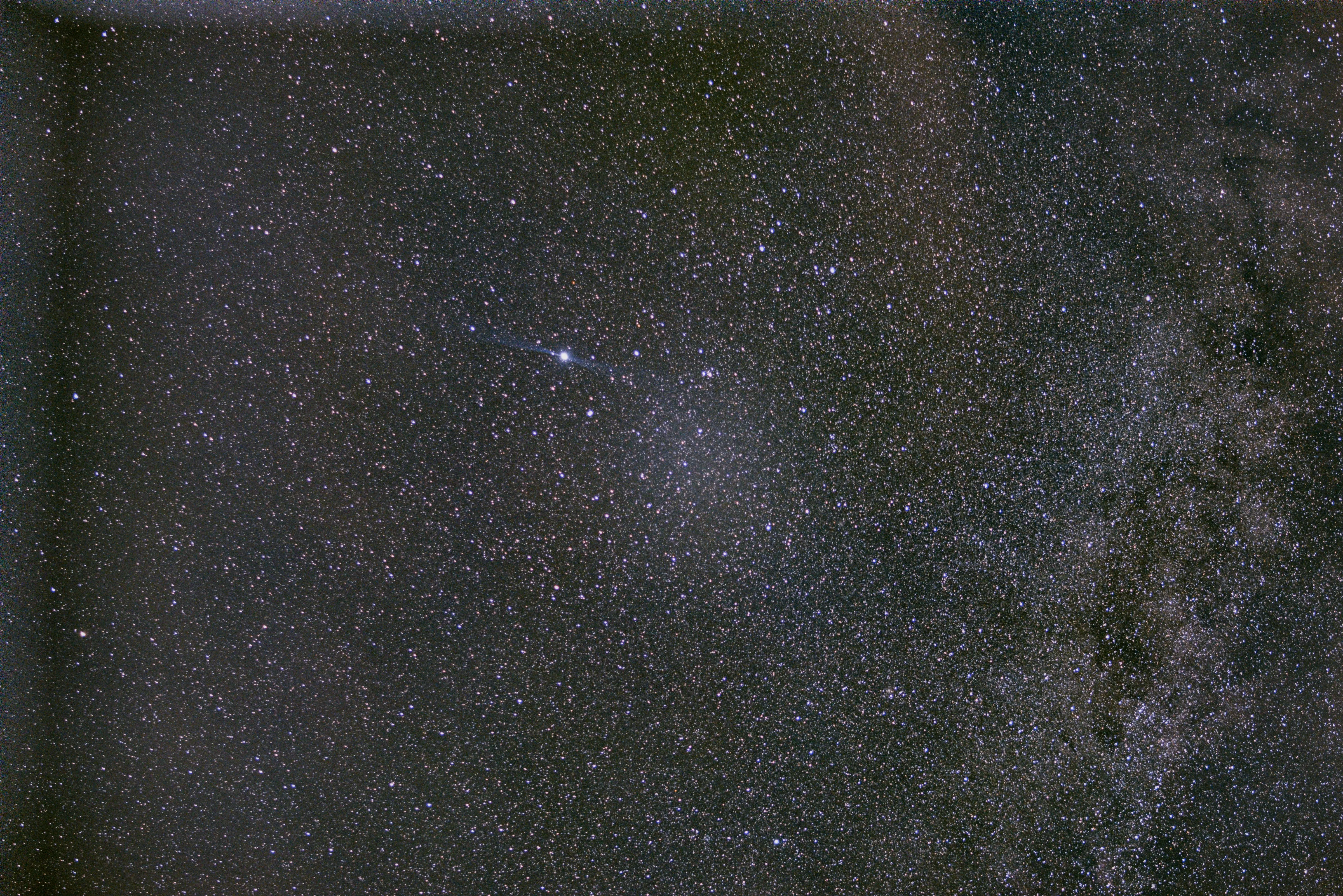 A dense field of stars and the Milky Way crossing a dark night sky